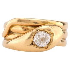 Center Stone: Old Mine Cut Diamond Weight: Approximately .70 Carat Color: J Clarity: SI Metal: 18K Yellow Gold Era: Victorian Circa: 1904's Hallmarks: Birmingham Hallmarks Size: 9.75 and can be resized Gram weight: 8.25 This enchanting Victorian snake ring, crafted in 18K yellow gold, features a captivating .70 carat old mine cut diamond at its center. The diamond, graded J in color and SI in clarity, is beautifully set within the coiled serpent design, a symbol of eternal love and wisdom during the Victorian era. Hallmarked with Birmingham marks and weighing 8.25 grams, this ring from the early 1900s exudes both charm and vintage elegance. Sized at 9.75, it can be resized to fit, making it a stunning and meaningful addition to any fine jewelry collection. Antique Cocktail Ring, Victorian Diamond Ring, Three Stone Diamond Ring, Old Mine Cut Diamond, Three Stone Diamond, Victorian Rings, Snake Ring, 18k Yellow Gold Ring, Gold Snake