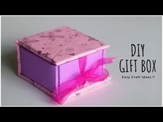 a pink and purple gift box sitting on top of a white surface with the words diy gift box easy craft ideas