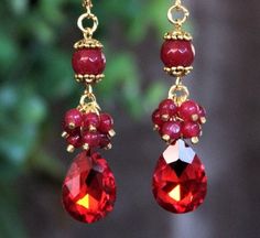 Elegant, opulent, and shimmery These fabulous vintage inspired earrings can be worn in many occasions. The classic style make these earrings timeless. This brilliant classic earrings features Swarovski garnet crystal teardrop. Crystals are set on a secure prong settings, made of brass and plated in gold. Accented with cluster of small ruby jade and red jade gemstones. Hanging from a surgical steel lever-back, it measures 2.5" in length. Earrings are light weight and sway gracefully as you move about your day. These beautiful jeweled earrings are unique, feminine and eye-catching, a perfect accent for a special event or add a touch of sparkle to your everyday wardrobe. Elegant Christmas Anniversary Earrings, Classic Red Earrings For Party, Classic Red Party Earrings, Glamorous Red Earrings For Wedding, Elegant Red Bridal Earrings For Anniversary, Glamorous Red Wedding Earrings, Red Dangle Bridal Earrings For Anniversary, Elegant Handmade Red Crystal Earrings, Red Earrings For Christmas Wedding