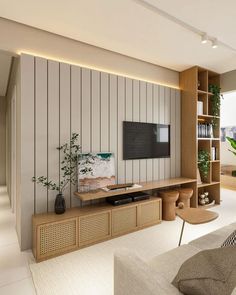 a living room filled with furniture and a flat screen tv on top of a wooden shelf