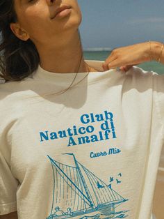 Set sail with our "Amalfi Nautical Club" Tee! ⚓ This vintage-inspired graphic T-shirt captures the essence of coastal living, perfect for maritime enthusiasts and beach lovers. Crafted from soft, breathable cotton, it offers both comfort and style for any occasion. Add a touch of seaside charm to your wardrobe with this elegant tee! Details: Material: 100% Cotton Sizes: XS, S, M, L, XL, XXL Care: Machine wash cold, tumble dry low Designed with love and crafted for comfort ❤️ Tags: amalfi nautica Vintage Tshirt Design, Vintage Nautical, Casual Summer Tops, Club Shirts, Tee Shirt Designs, Beach Lovers, Coastal Style, Summer Top, Amalfi