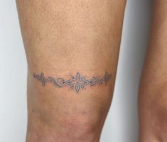 a woman's legs with tattoos on them