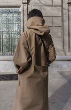 Fabric: 73% Cotton, 27% NylonColor: Light BrownCare: Hand wash / Dry clean Waterproof oversized hooded trench coat with two front pockets and centre front bottom closure. The length is 46-47 inches (118-120 cm). Unlined. Consider wearing at a temperature 68-50°F (20-10°C) Made in USA. Yellow Parka, Pijamas Women, Khaki Trench, Khaki Trench Coat, Hooded Trench Coat, Statement Coat, Trench Coat Style, Hooded Raincoat, Trench Coat Black