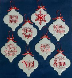 six christmas ornaments with red and white designs hanging on a blue background, each ornament has a different saying