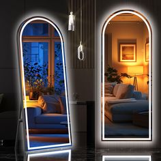 two large mirrors with lights on them in front of a couch and window at night