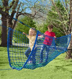 two children playing on a blue play net