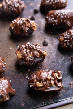 chocolate covered pretzels with nuts and sesame seeds on a baking sheet, ready to be eaten