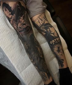 a man's leg with tattoos on it and his arm is covered in black ink