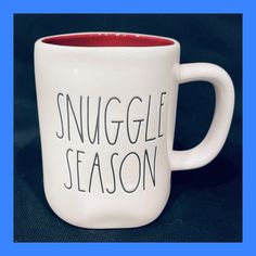 a coffee mug with the words snuggle season written on it in black and red