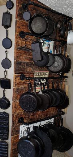 there are many pans hanging on the wall