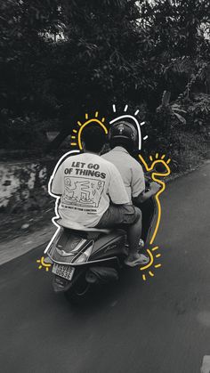 two people riding on the back of a scooter down a road with trees in the background