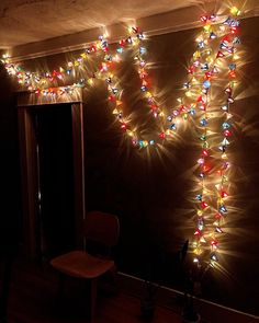 a room with lights on the wall and a chair