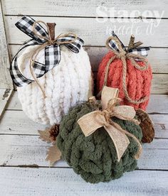 three crocheted pumpkins with bows on them