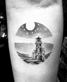 a black and white photo of a lighthouse tattoo