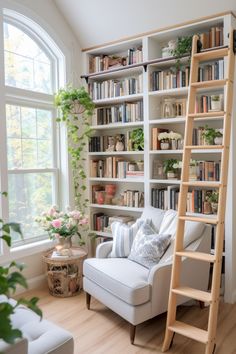 a white chair sitting in front of a window next to a book shelf filled with books