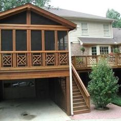 a two story house with wooden balconies on the front and second story above it