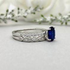 This beautiful ring is made from genuine 925 sterling silver with rhodium plating. Ring details- -The Main stone is an oval cut 8mm by 6mm Lab Created Blue Sapphire Stone -Side stones are 1.2 Round simulated diamonds -Ring is casted in solid 925 sterling silver with rhodium plating (yellow gold and rose gold plated also available, please check the drop down menu for more options) -The Total face height of the ring measures 8mms and the band width measures 2mms -Each ring is handmade and made to Oval Cubic Zirconia Stackable Rings, Oval Cubic Zirconia Stackable Rings With Prong Setting, Oval Cubic Zirconia Stackable Rings In Fine Jewelry Style, Oval White Gold Stackable Rings With Cubic Zirconia, Oval Cubic Zirconia Stackable Rings For Gift, 14k White Gold Oval Wedding And Promise Jewelry, Formal Oval Sapphire Stackable Ring, Oval Sapphire Ring For Promise, 14k White Gold Oval Promise Ring