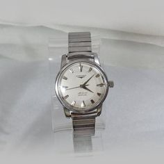 This vintage Longines watch is amazing!  This is the 1956 All Guard men's watch, and it is just spectacular!  This silver stainless steel men's watch features a very easy to read design with a sweeping second hand, a silver face and silver hash marks.  This beautiful rare watch is in excellent working condition.  The band appears to be a replacement expansion band by Spiegel, but otherwise the watch appears to be original.  The back of the watch reads Longines, Shock Guard, Synchro Guard, Water Vintage Silver Watch With Analog Display, Vintage Formal Watches With Analog Display, Vintage Watch Accessories With Subdials For Anniversary, Vintage Chronometer Watch For Anniversary, Vintage Chronometer Watches For Anniversary, Retro Silver Watch Accessories For Anniversary, Retro Analog Watch For Anniversary, Vintage Jewelry And Watches With Automatic Round Dial, Retro Automatic Watch Accessories For Anniversary