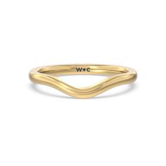 a yellow gold ring with the word w o on it's side, in front of