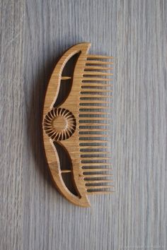 a wooden comb with an intricate design on it