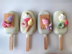 four ice cream pops with different designs on them