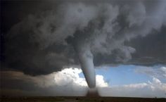 a large tornado is seen in the sky