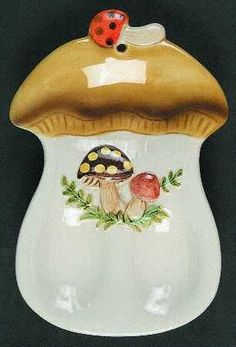 a ceramic mushroom with ladybugs on it