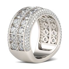 Celebrate your everlasting love story with this elegant band. Stunning as a wedding or anniversary band, two rows of sparkling round stones are set across the center of this band and split by a row of smaller round stones - decorates the ring's impressive shank. A double row of smaller round stones grace the top and bottom of the band, completing this exceptional design. This band is a beautiful reminder of your timeless romance.Carat Weight: 6.575 ctStone Size: 3,1,1.2 mmStone Type: Jeulia® Sto White Bling Rings For Anniversary, Wedding Jewelry With Channel Set Wide Band, Dazzling Sparkling Diamond Wedding Ring, White Gold Rings With Bling For Wedding, Anniversary White Gold Diamond Ring With Bling, Wedding Rings With Bling And Round Cut, Classic Rings With Bling For Anniversary, Classic Anniversary Ring With Bling, Classic Anniversary Rings With Bling