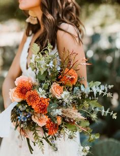 a woman holding a bouquet of flowers in her hands