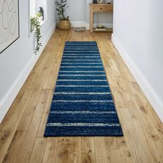 a blue rug on the floor in a hallway