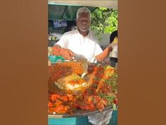 a man standing in front of a large platter of food