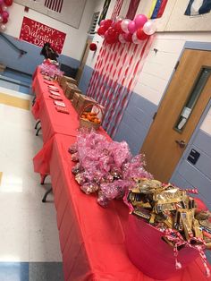 a red table topped with lots of candy