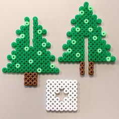 two pieces of lego art made to look like trees and the letter e is for o