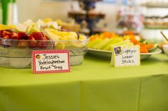 a table topped with lots of different types of fruit and veggie platters