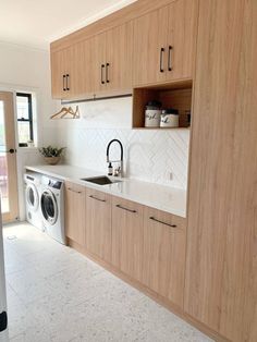 the kitchen is clean and ready to be used as a washer and dryer