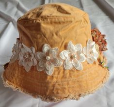 A fun summer, fall hat complete with a bow,  flowers and pretty broaches.  Great for the beach or a day or evening on the town that makes a statement. Free shipping from my store on orders over $35. Handmade Flower Hats For Summer, Whimsical Fedora Hat For Beach, Whimsical Fedora Beach Hat, Whimsical Short Brim Beach Hat, Bohemian Flower Sun Hat For Beach, Whimsical Fedora For Beach, Bohemian Flower Shaped Sun Hat For Beach, Whimsical Brimmed Sun Hat For Beach, Whimsical Bucket Hat For The Beach