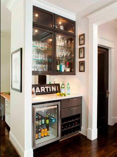 a home bar with wine glasses and liquor bottles