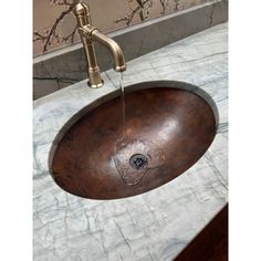 a bathroom sink that has a faucet running from it's center drain