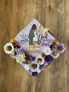 a purple and gold graduation cap with flowers on it that says, i choose path to god