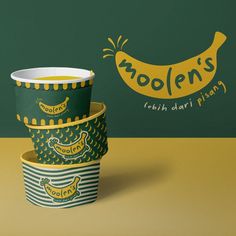 three paper cups are stacked on top of each other in front of a green and yellow wall