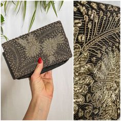 a woman's hand holding a black and gold clutch bag next to an image of a plant