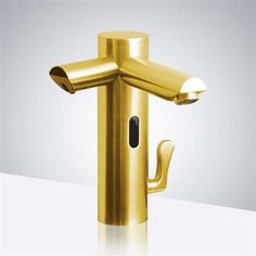 a gold colored faucet on a white surface