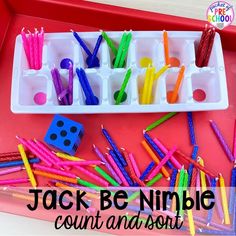 a tray filled with lots of colorful toothbrushes and some dices on it