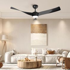 a living room filled with furniture and a ceiling fan in the middle of the room