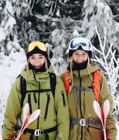 two women standing next to each other in the snow