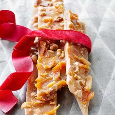 a close up of a candy bar with a red ribbon on it's side