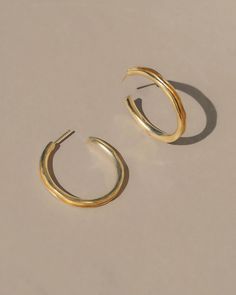 An exploration of technique, shape, and movement, these hollow cut hoops offer an organic simple and lightweight design perfect for everyday, anytime, anywhere. Material: Gold Vermeil (14k gold over sterling silver)7 grams, 1.5". Sold as a pairMade with recycled metals in the USACARE: Most metals will naturally patina over time, however, there are measures you can take to prolong the life of your jewelry. We recommend removing all jewelry prior to showering, swimming, cleaning, or applying lotio Modern Recycled Gold Hoop Earrings For Everyday, Gold Hammered Hoop Earrings In Recycled Gold, Hammered Gold Hoop Earrings In Recycled Gold, Hammered Yellow Gold Hoop Earrings In Recycled Gold, Minimalist 14k Gold Hand Forged Hoop Earrings, Minimalist Hand-forged 14k Gold Hoop Earrings, Hammered Recycled Gold Hoop Earrings, Hammered Round Hoop Earrings In Recycled Gold, Minimalist Polished Brass Hoop Earrings