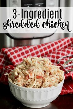 a bowl filled with shredded chicken next to an instant pressure cooker in the background