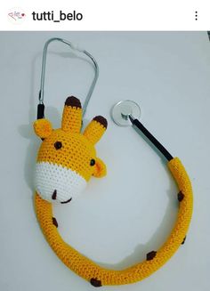 a crocheted giraffe with a stethoscope attached to it