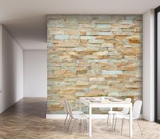 a dining room table and chairs in front of a stone wall